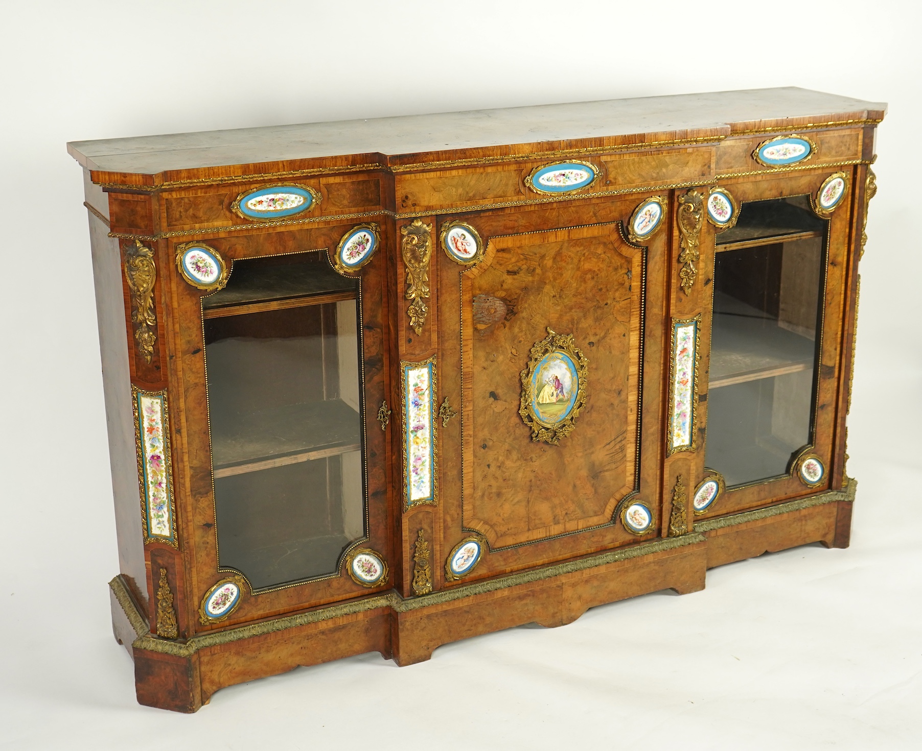 A Victorian tulip banded and gilt metal mounted walnut breakfront side cabinet